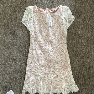 White cocktail dress perfect for bridal events.